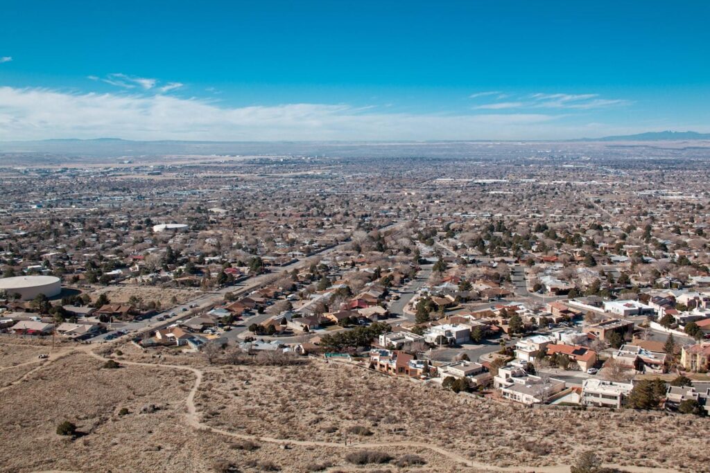 Albuquerque, New Mexico — cheap places to travel in USA Aerial view of Albuquerque, New Mexico showcasing desert scenery and urban layout. — cheap places to travel in USA