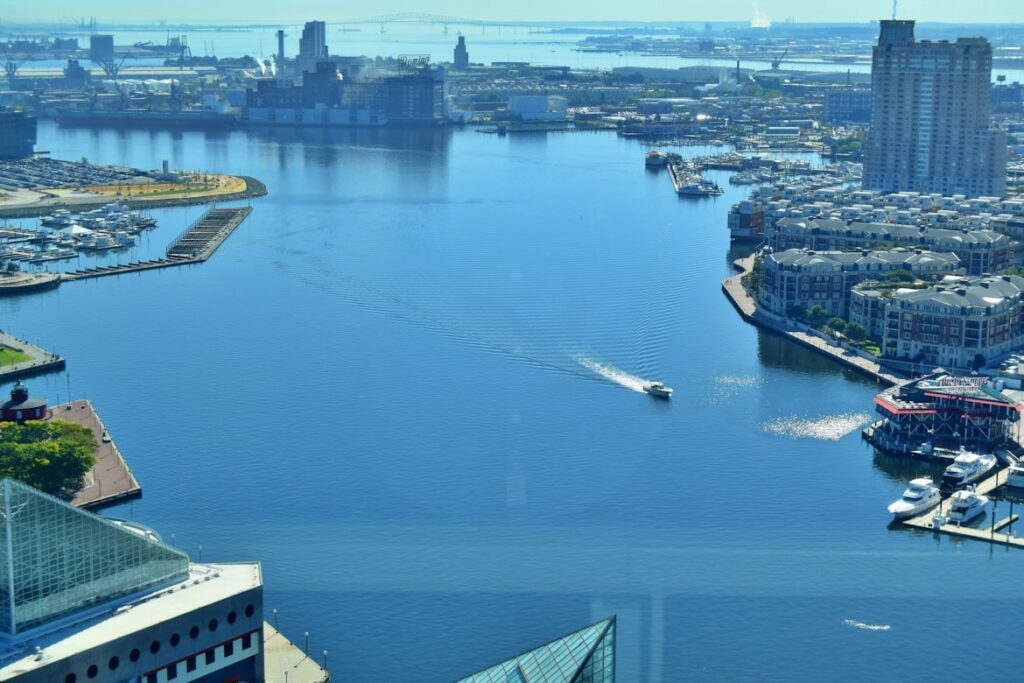 Baltimore Inner Harbor View — cheap places to travel in USA View of Baltimore's Inner Harbor with boats and waterfront buildings — cheap places to travel in USA