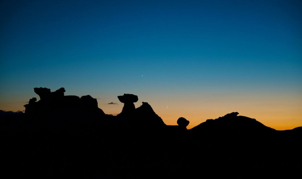 Bisti/De-Na-Zin Wilderness at Twilight — secret places in the USA Silhouetted rock formations against a twilight sky in Bisti/De-Na-Zin Wilderness, New Mexico. — secret places in the USA
