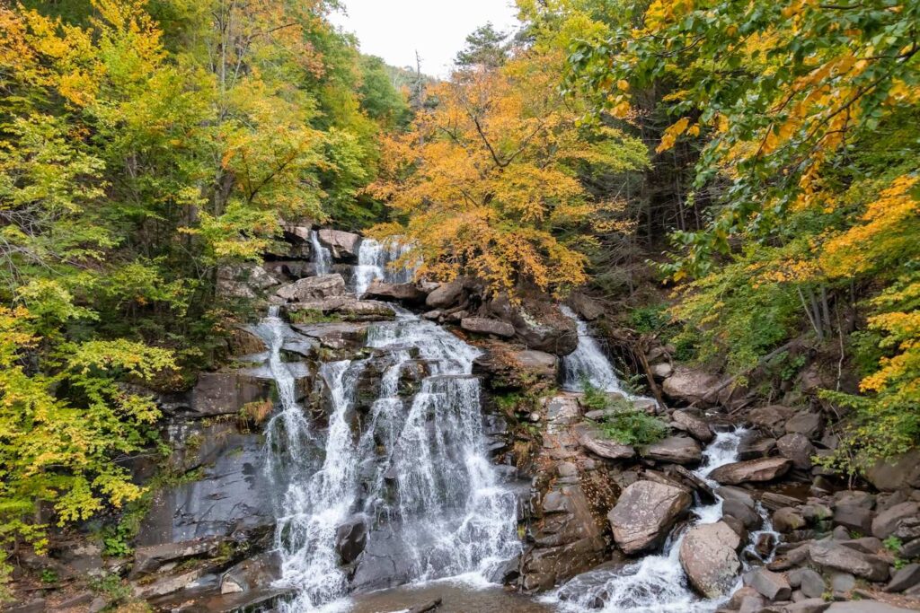 Catskills Waterfall in Autumn — road trip USA ideas Waterfall surrounded by autumn foliage in the Catskills — road trip USA ideas