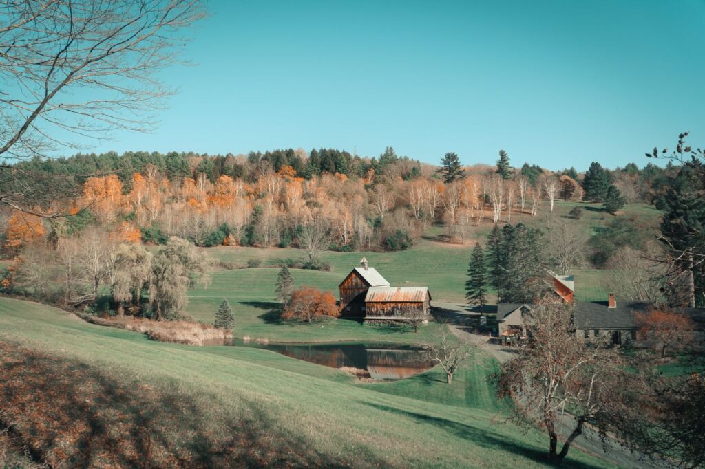 Charming Small Town Landscape — charming small towns in the USA Scenic view of a charming small town with autumn foliage and a rustic barn. — charming small towns in the USA