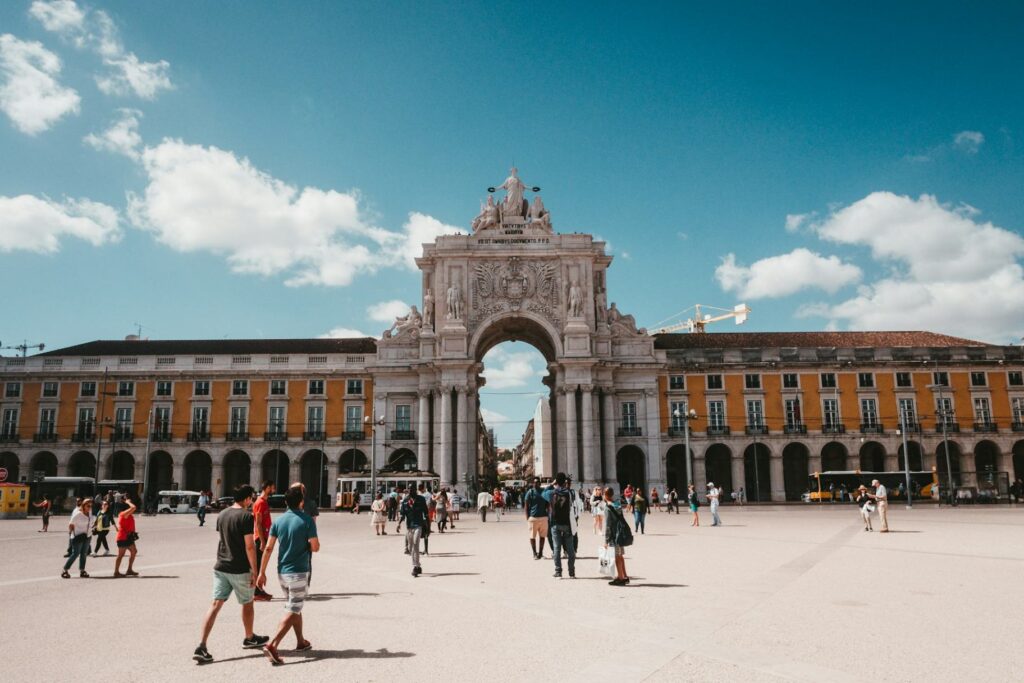 Lisbon's Arco da Rua Augusta — Europe travel destinations Lisbon, Portugal's iconic Arco da Rua Augusta with people walking below. — Europe travel destinations