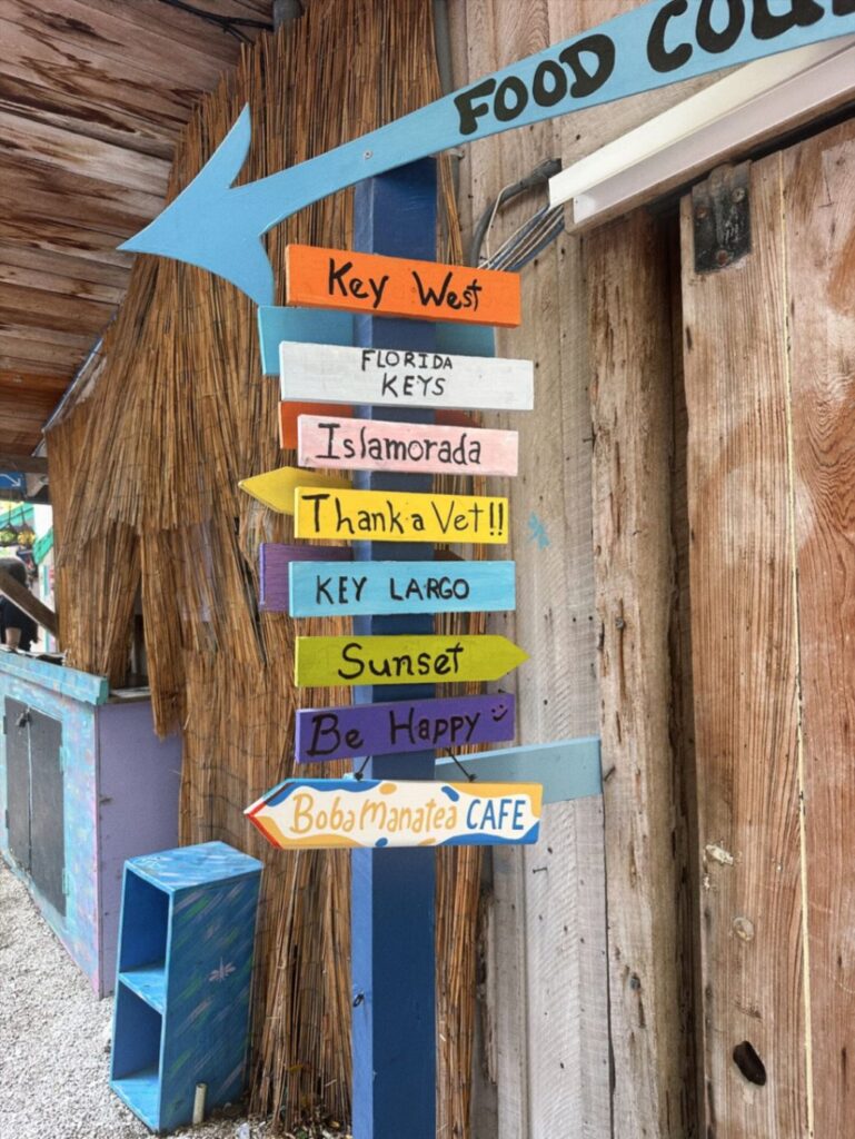 Florida Keys Directional Signs — RV USA road trip routes Colorful directional signs in the Florida Keys pointing to various locations. — RV USA road trip routes
