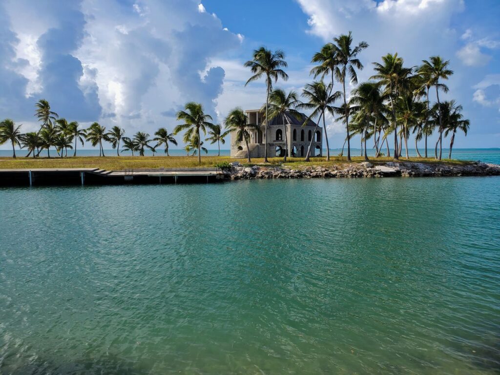 Florida Keys Waterfront — road trip USA ideas Scenic view of a waterfront with palm trees and a historic building in the Florida Keys. — road trip USA ideas