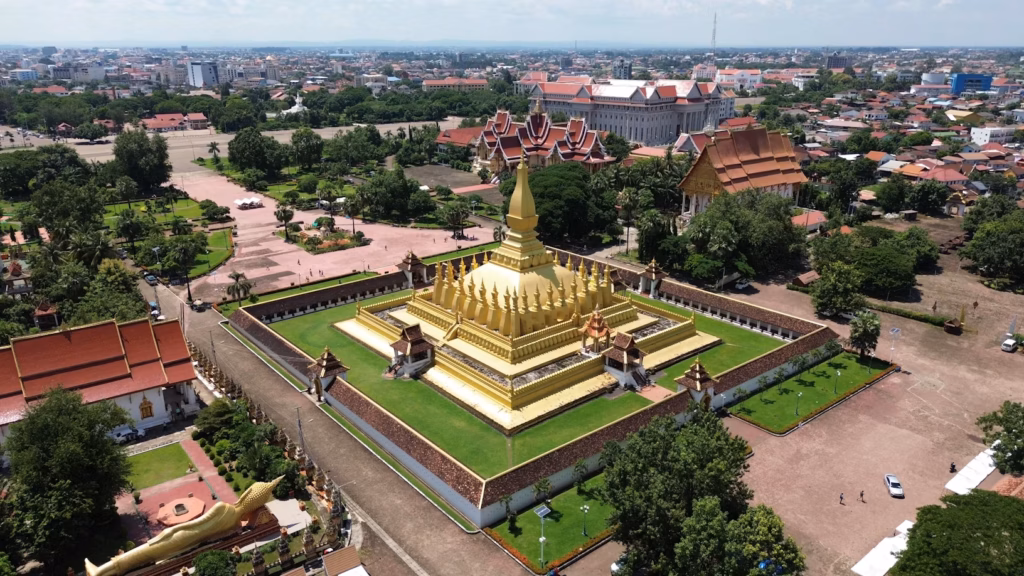 Golden Temple in Laos — underrated countries to visit Stunning aerial view of a golden temple in Laos surrounded by lush greenery and traditional — underrated countries to visit