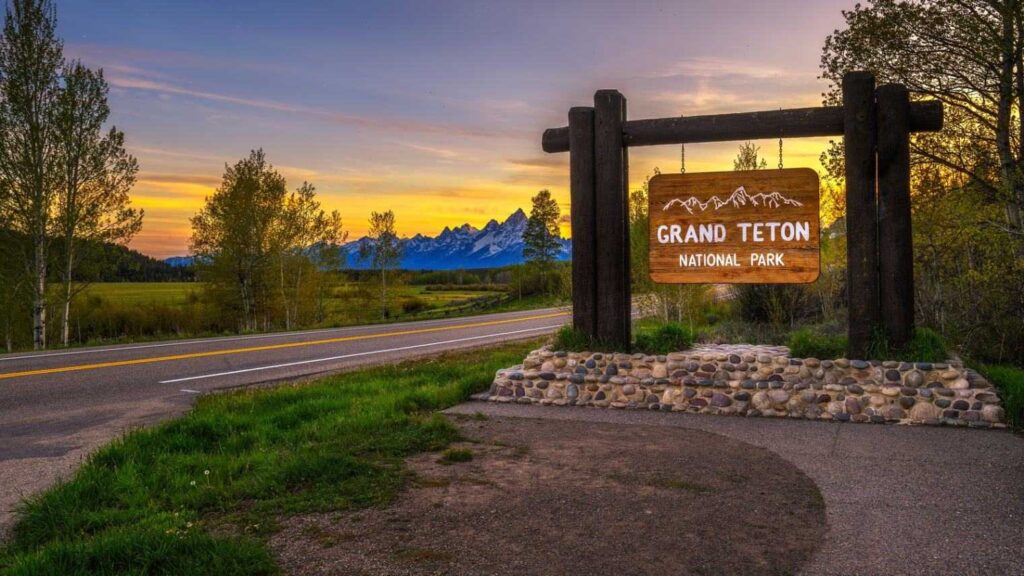 Grand Teton National Park — USA Road Trips Grand Teton National Park entrance sign at sunset — USA Road Trips
