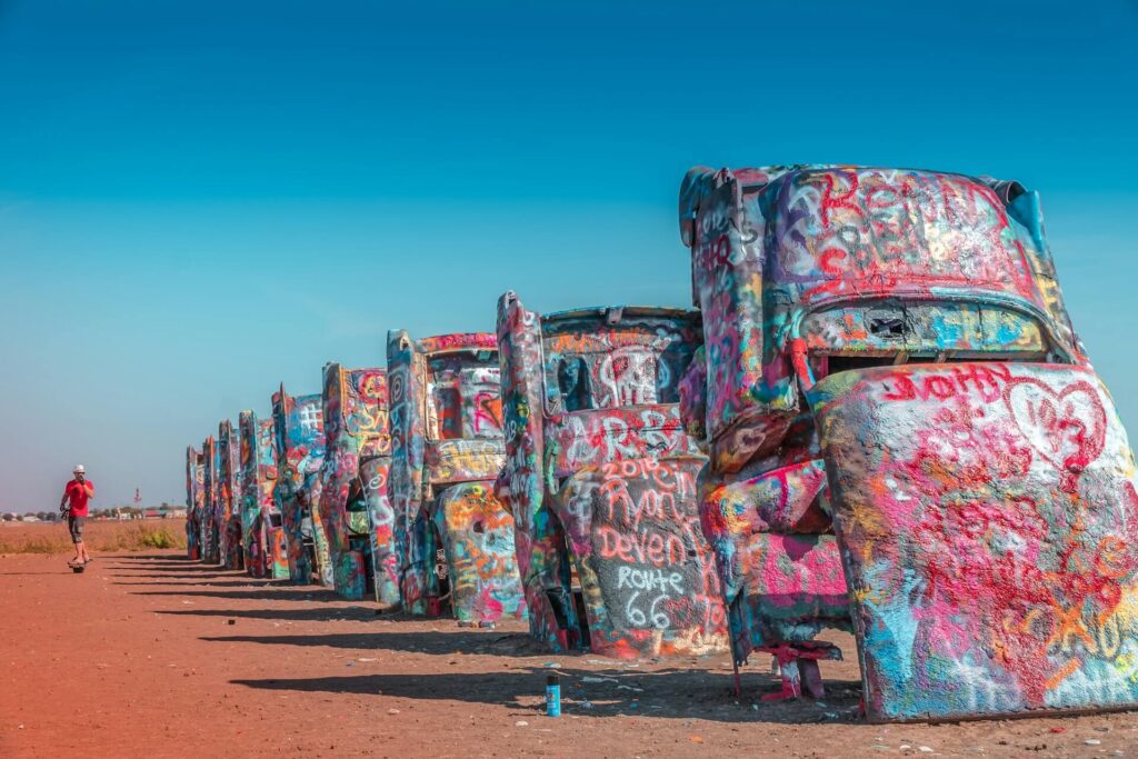 Historic Route 66 Cars — RV USA road trip routes Colorful graffiti-covered cars lined up in a desert landscape. — RV USA road trip routes
