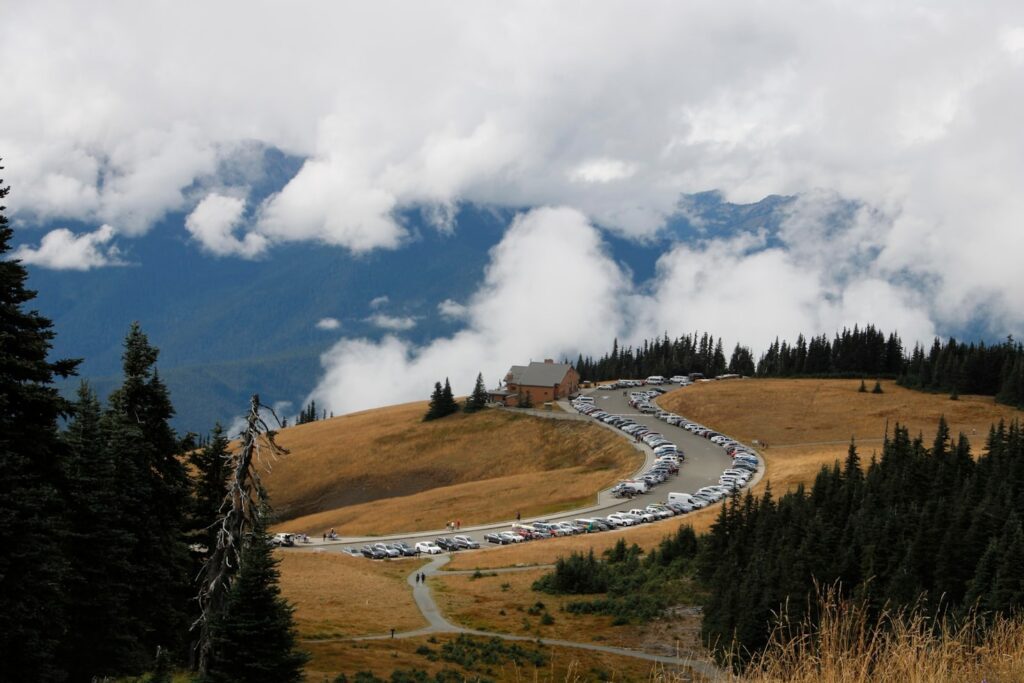 Hurricane Ridge Scenic View — Places to Visit in the Western USA Scenic view of Hurricane Ridge with parking area and mountains in the background — Places to Visit in the Western USA