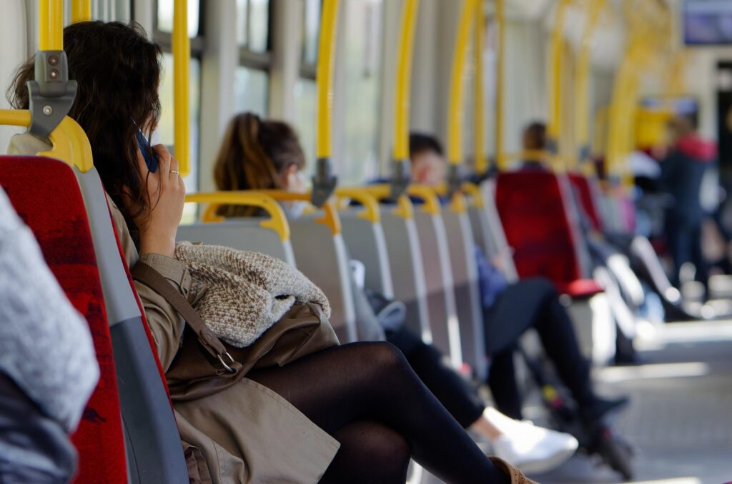 Using Public Transportation for Budget Travel — Budget Travel Tips Public transportation interior with passengers seated — Budget Travel Tips