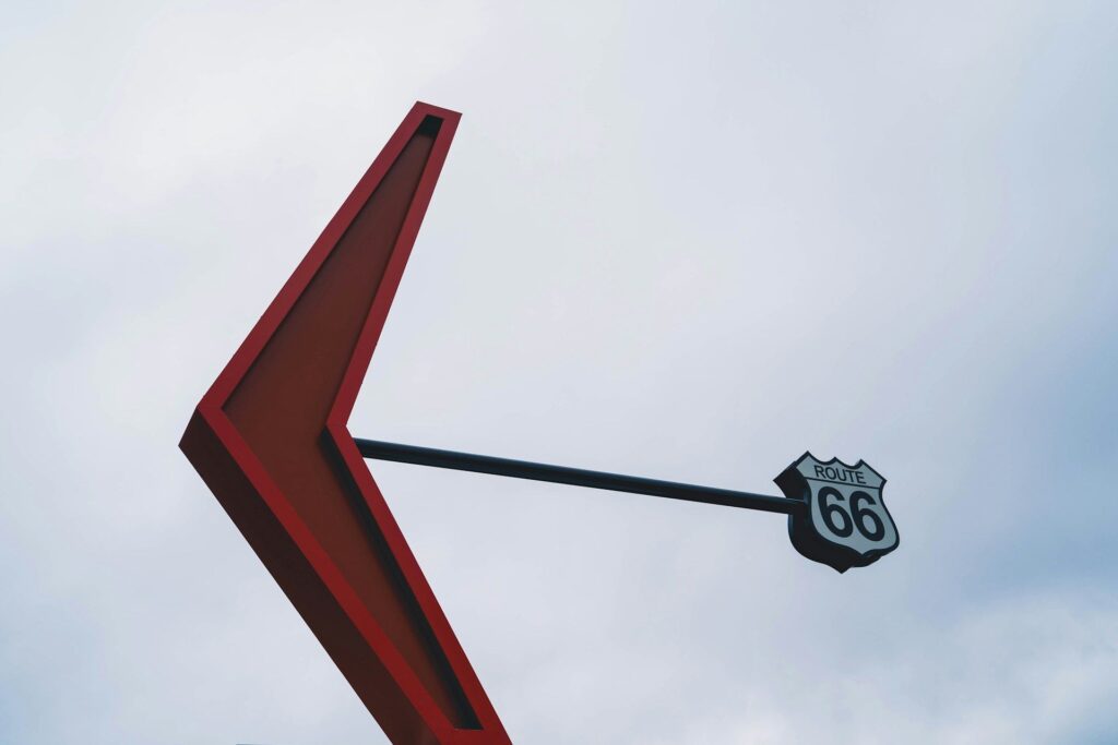 Route 66 Sign in Flagstaff — Sedona to Grand Canyon drive stops Route 66 sign with a large red arrow pointing left — Sedona to Grand Canyon drive stops