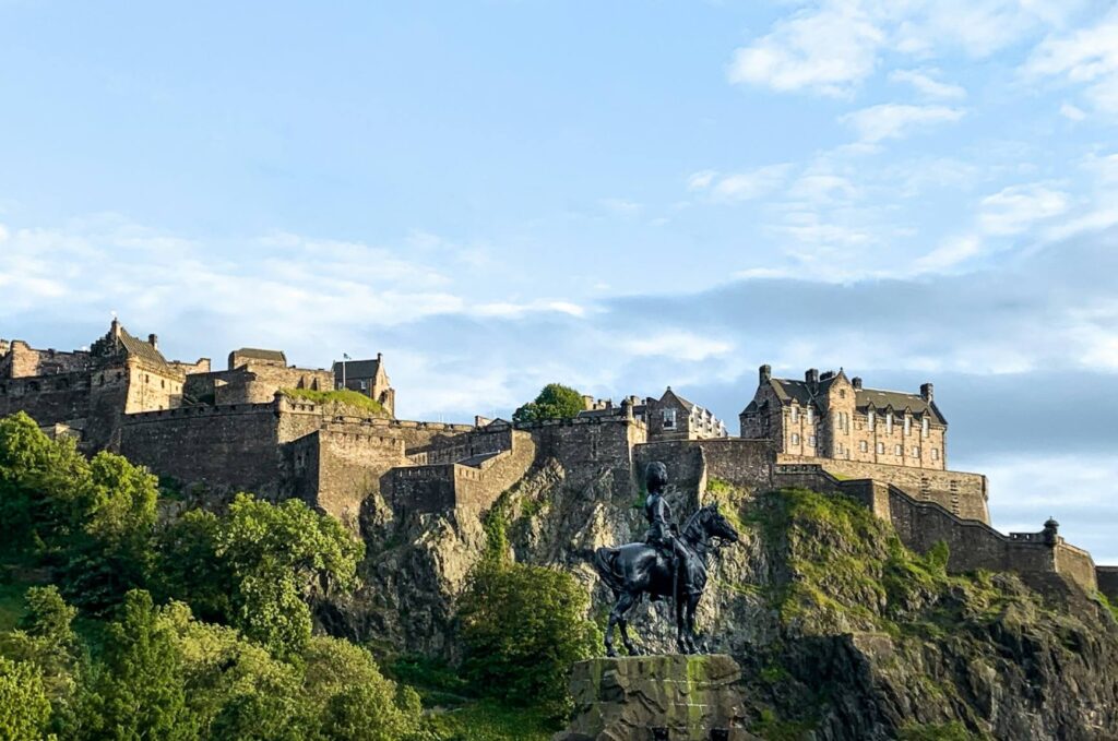 Edinburgh Castle View — Europe travel destinations Edinburgh Castle on a rocky hill with a statue in the foreground — Europe travel destinations