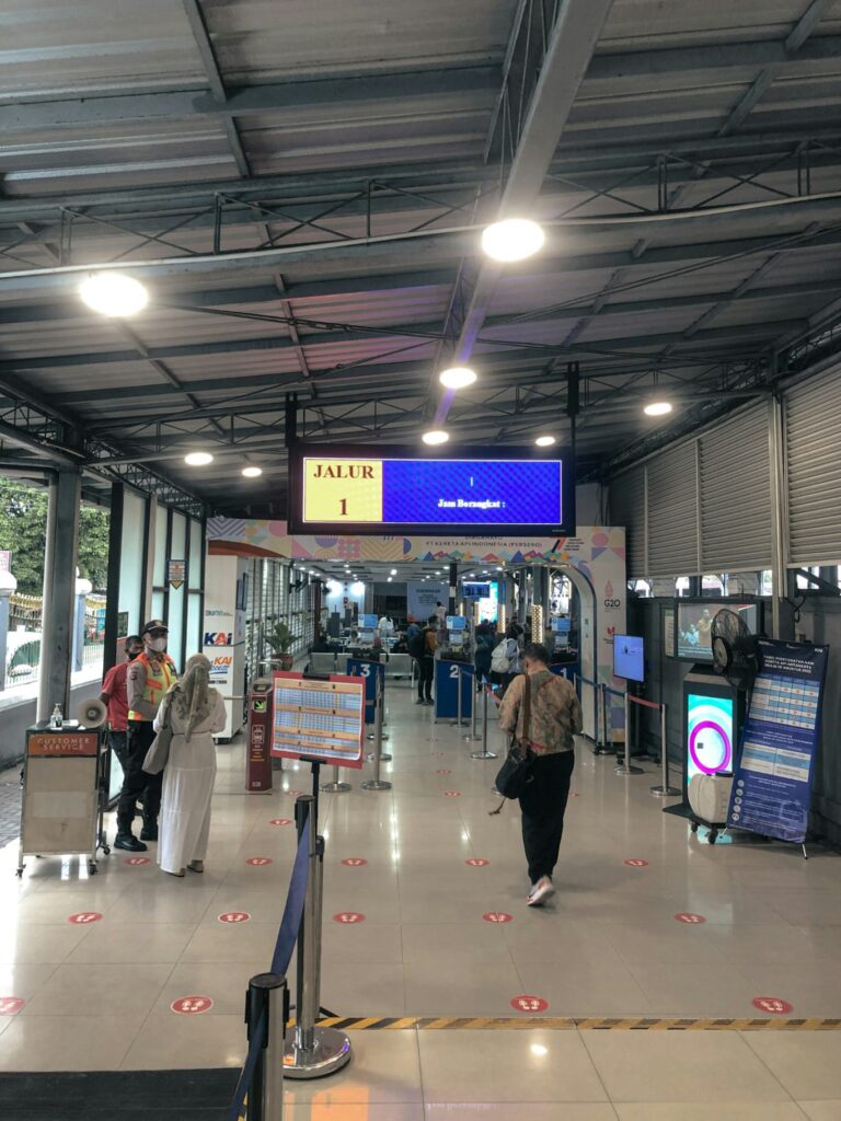 Travel Packing Essentials — carry-on packing essentials Airport terminal with travelers and signage — carry-on packing essentials