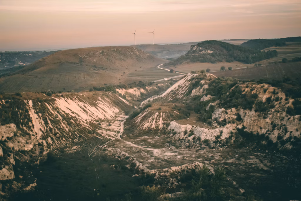 Moldova's Scenic Countryside — underrated countries to visit Scenic view of Moldova's countryside with wind turbines in the distance. — underrated countries to visit