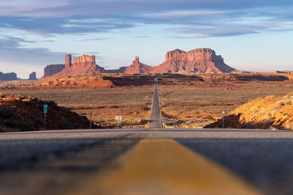 Monument Valley Road — RV USA road trip routes Monument Valley landscape with a long road leading into the distance — RV USA road trip routes