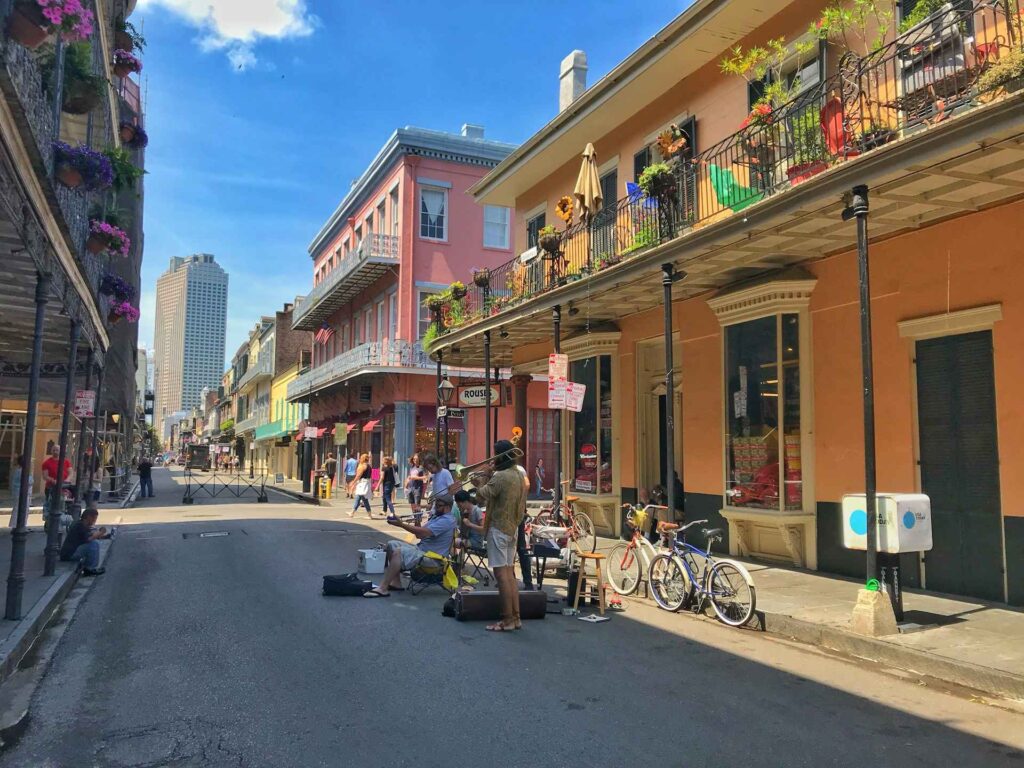 New Orleans Street Scene — best weekend getaways USA Street scene in New Orleans with musicians and colorful buildings — best weekend getaways USA