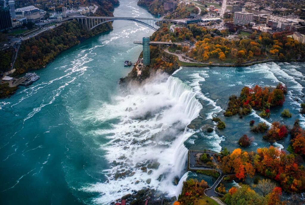 Niagara Falls Aerial View — best weekend getaways USA Aerial view of Niagara Falls showcasing the waterfalls and surrounding autumn foliage. — best weekend getaways USA