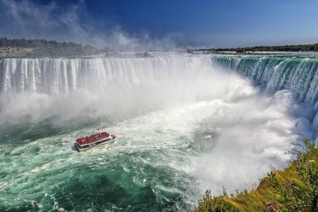 Niagara Falls View — beautiful places in America to visit Niagara Falls with a boat near the powerful waterfall, showcasing a beautiful place — beautiful places in America to visit