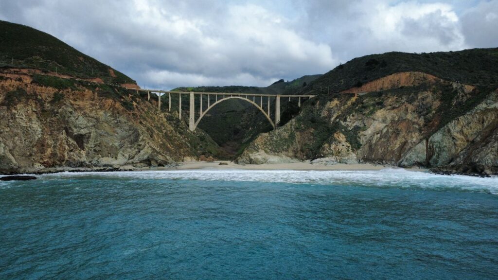 Pacific Coast Highway Overview — RV USA road trip routes Pacific Coast Highway view with bridge and ocean — RV USA road trip routes