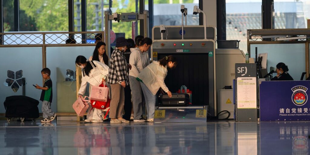 Airport Security Screening Process — smoother airport experience Passengers going through airport security screening with luggage. — smoother airport experience