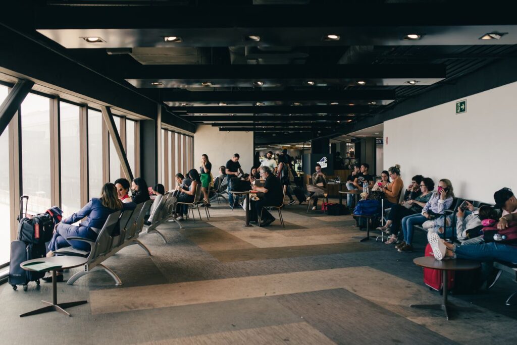 Airport Lounge with Passengers — smoother airport experience Passengers waiting in an airport lounge during a flight delay — smoother airport experience