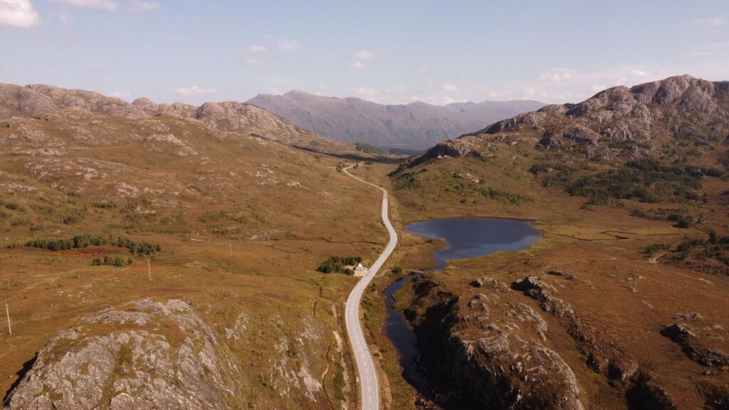 Scenic Road in Scottish Highlands — beautiful getaways in Europe Scenic road through the Scottish Highlands with mountains and a loch — beautiful getaways in Europe