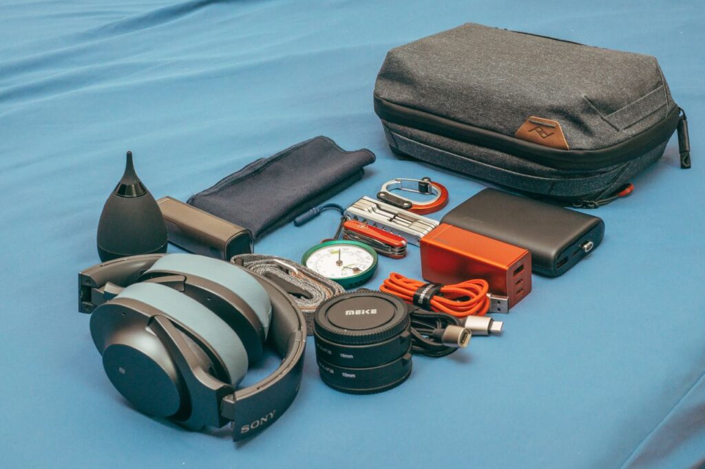 Travel Essentials for Technology Travel essentials including headphones, chargers, and a power bank.