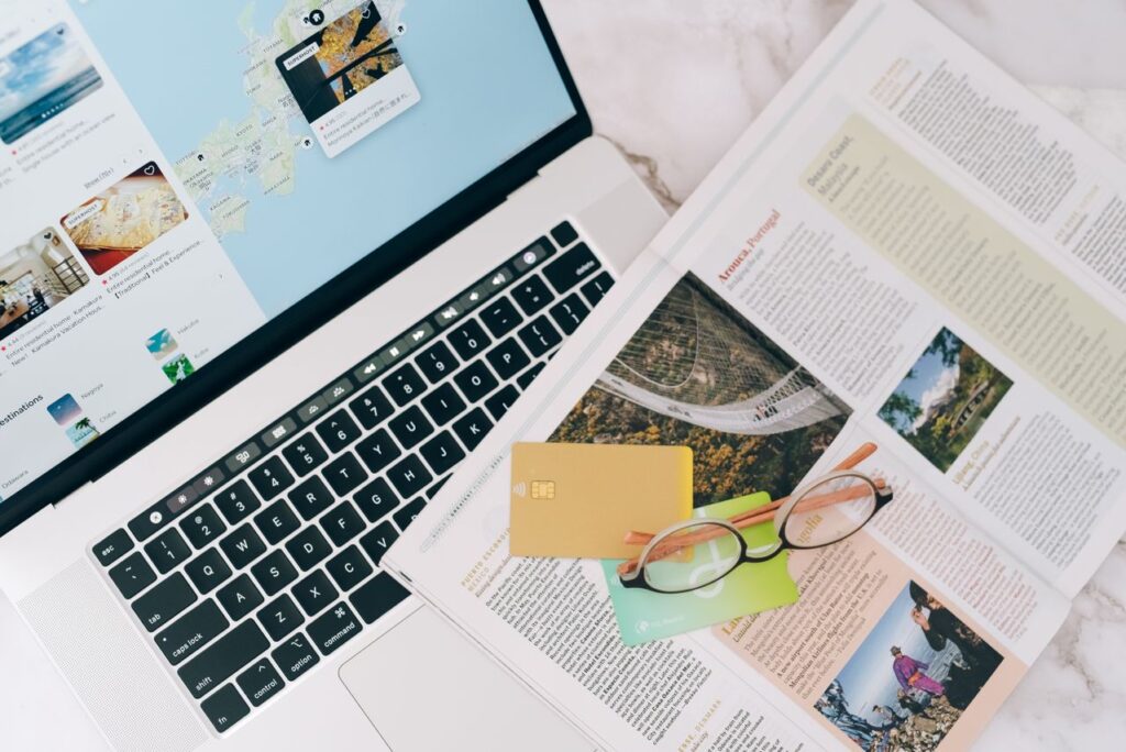Travel Planning Essentials — easier vacation planning tips Laptop with travel planning materials and credit cards — easier vacation planning tips