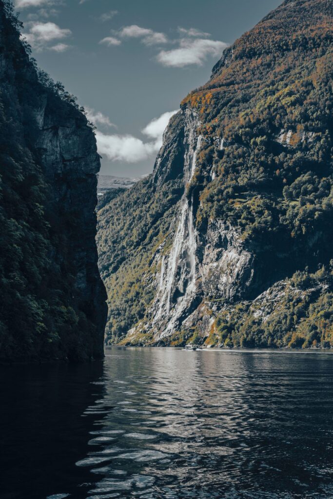 Norwegian Fjords Landscape — beautiful getaways in Europe Norwegian fjords with mountains and a waterfall — beautiful getaways in Europe