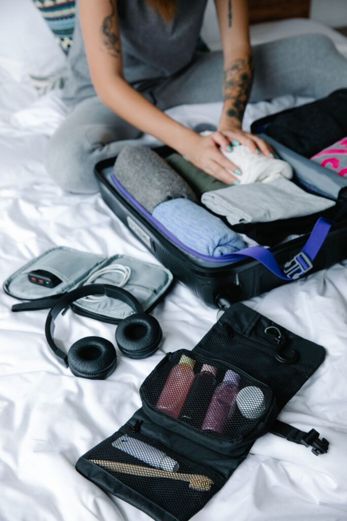 Travel Essentials Checklist Items Travel essentials checklist items packed in a suitcase.