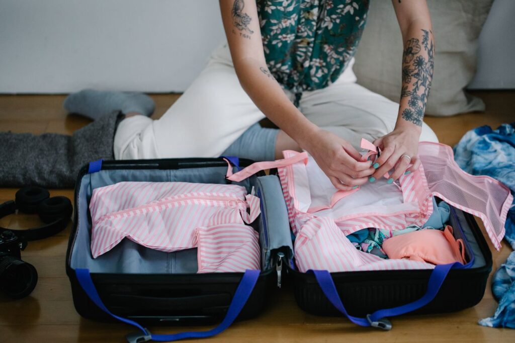 Packing Travel Essentials — travel essentials for women Packing travel essentials for women in a suitcase
