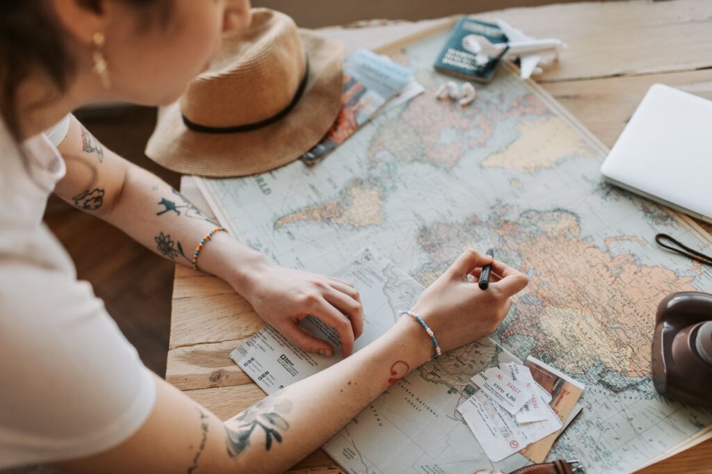Travel Planning Essentials — easier vacation planning tips Person planning a trip with a map and travel documents. — easier vacation planning tips