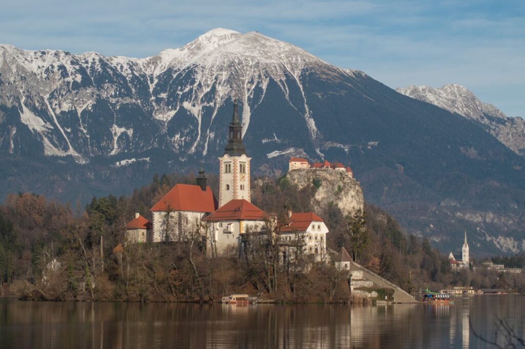 Lake Bled, Slovenia — beautiful getaways in Europe Lake Bled, Slovenia with church and castle in the Alps — beautiful getaways in Europe