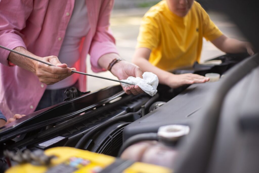 Preparing Your Car for a Road Trip — USA cross-country road trip Preparing a car for a long road trip with a child helping. — USA cross-country road trip