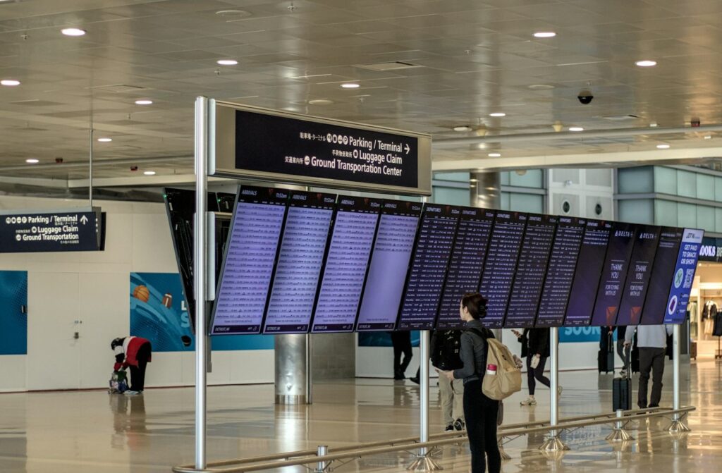 Airport Transportation Tips — Budget Travel Tips Airport transportation display board showing flight information — Budget Travel Tips