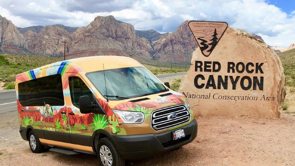Red Rock Canyon, Nevada — hidden gems in the USA Red Rock Canyon sign with a colorful van in front — hidden gems in the USA