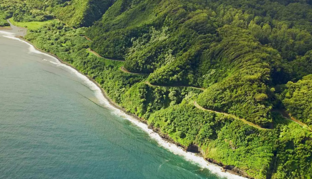 Road to Hana Scenic View — beautiful places in America to visit Scenic view of the Road to Hana, showcasing lush green hills and a winding coastal — beautiful places in America to visit