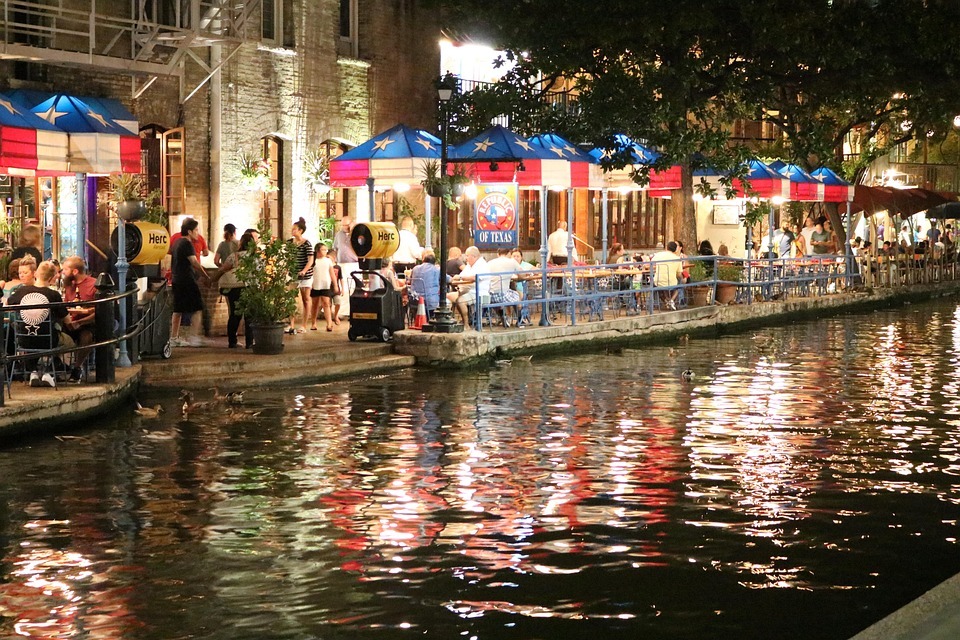 San Antonio River Walk — cheap places to travel in USA San Antonio River Walk at night with restaurants and reflections in the water — cheap places to travel in USA
