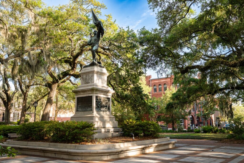 Savannah Historic District — best weekend getaways USA Savannah Historic District statue surrounded by trees and buildings — best weekend getaways USA
