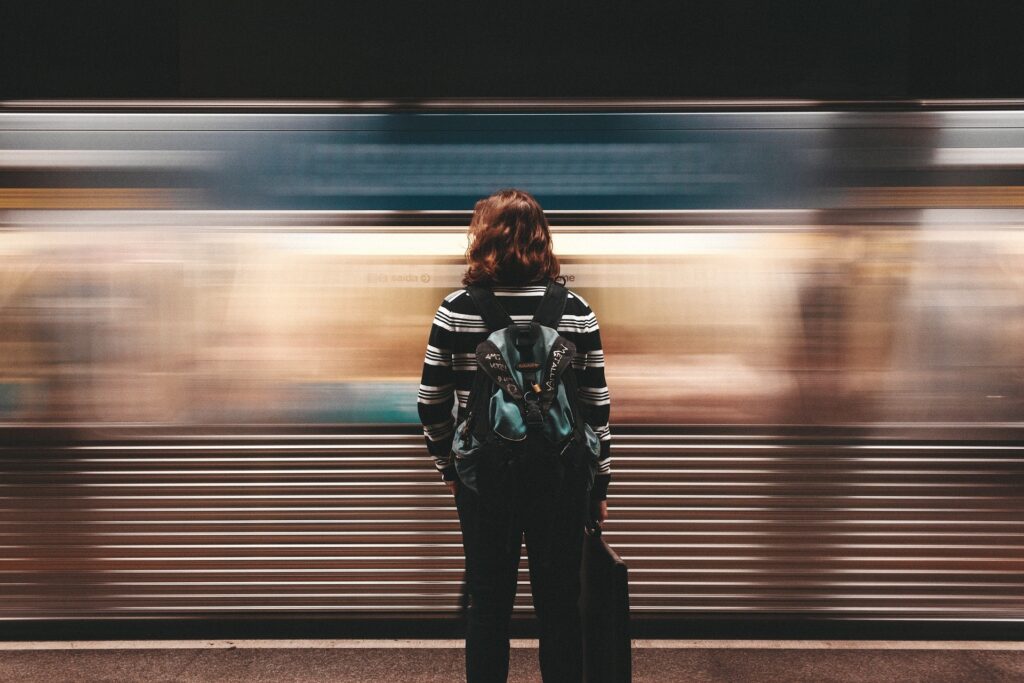 Transportation Decisions for Solo Travelers — Solo Travel Safety Tips Solo traveler waiting for transportation at a subway station. — Solo Travel Safety Tips