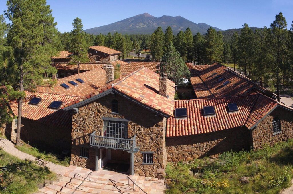 Museum of Northern Arizona — Sedona to Grand Canyon drive stops Museum of Northern Arizona building with surrounding trees and mountains — Sedona to Grand Canyon drive stops