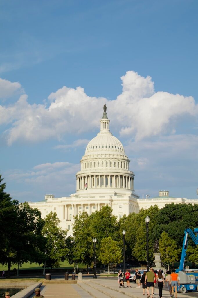 United States Capitol Building — cheap places to travel in USA The United States Capitol building under a blue sky with white clouds — cheap places to travel in USA