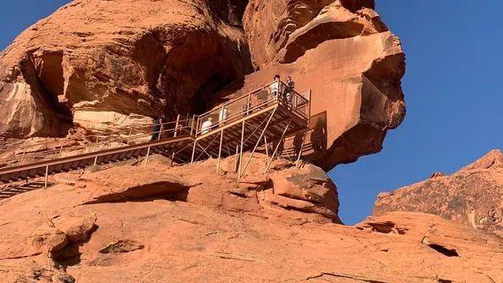 Valley of Fire Walkway — unique travel destinations in the USA Visitors on a wooden walkway at Valley of Fire State Park, surrounded by red rock — unique travel destinations in the USA