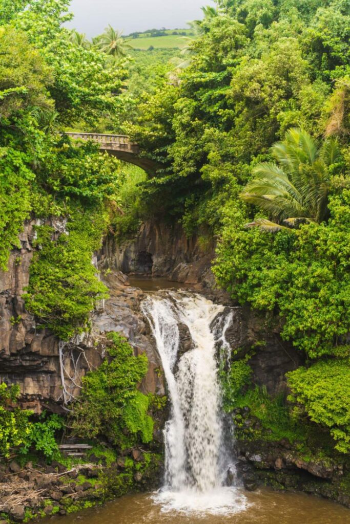 Waterfall on the Road to Hana — beautiful places in America to visit Beautiful waterfall surrounded by lush greenery on the Road to Hana in Hawaii. — beautiful places in America to visit