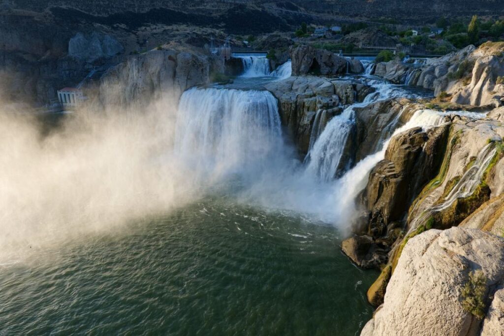 Waterfalls in Magic Valley, Idaho — secret places in the USA Waterfalls cascading into a river surrounded by rocky cliffs and mist, representing hidden gems — secret places in the USA