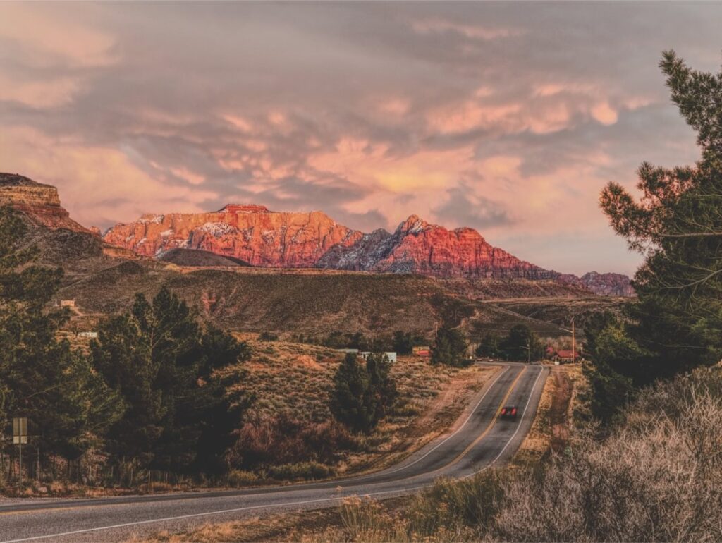 Zion National Park Sunset — road trip USA ideas Scenic view of mountains near Zion National Park during sunset. — road trip USA ideas